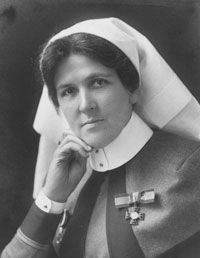 an old black and white photo of a woman wearing a nun's outfit with writing on it