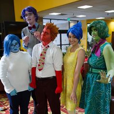 four people dressed up in costumes standing next to each other