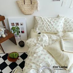 a bed sitting next to a table with a basket on it's headboard