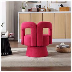 a pink chair sitting on top of a rug in a living room