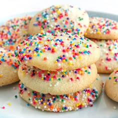 a plate full of cookies with sprinkles on them