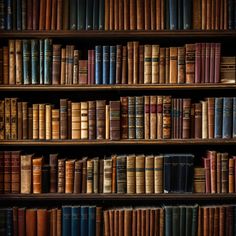 a bookshelf filled with lots of different colored books