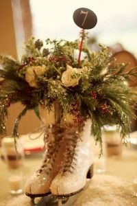 a close up of a boot with flowers and plants in it on top of a table