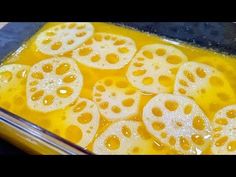 there are many slices of sliced fruit in the liquid inside an oven pan on the stove