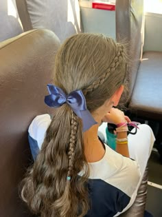 braid in ponytail with bow softball hairstyle Cheer Bows Hairstyles, Ponytail Hairstyles For Cheer, Cute Low Ponytails For Cheer, Gymnastics Bows Diy, Volleyball Hairstyles With Bow, Cheer Ponytail With Bow, Braid Into Ponytail Hairstyles, Cute Hairstyles For Cheerleaders, Curly Ponytail With Braid