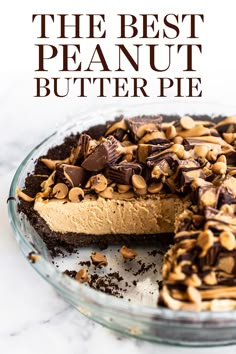 a pie with chocolate and peanut butter toppings is on a glass platter, ready to be eaten