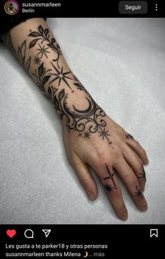 a woman's hand with tattoos on it