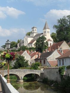 a river running through a small town next to a bridge