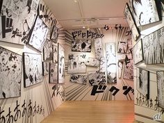 an art gallery with black and white drawings on the walls