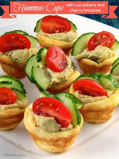 mini hummus cups with cucumber and cherry tomatoes on them are ready to be eaten