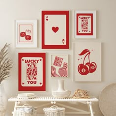 a white table topped with lots of framed pictures