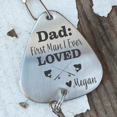 a metal keychain that says, dad first man i ever loved megan