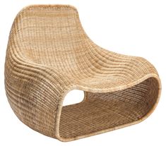 a chair made out of wicker with a hole in the back and seat cushion