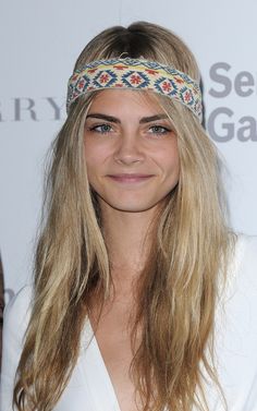 a woman with long blonde hair wearing a headband