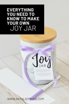 a jar with a tag on it sitting next to a piece of paper