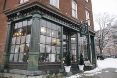 an old brick building with lots of windows on the outside and snow on the ground