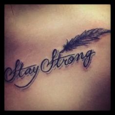 the word stay strong written in cursive ink on a woman's chest