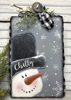 a snowman with a black hat and name on it