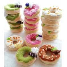 a table topped with lots of donuts covered in frosting