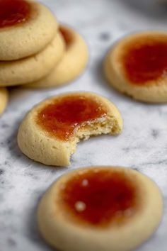 several cookies with jam on them sitting on a table