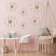 a room with pink walls and white flowers on the wall