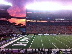 an empty football stadium with people sitting on the bleachers and watching the sun set