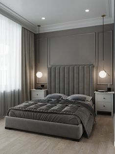 a large bed sitting in the middle of a bedroom next to two lamps on either side of it