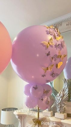 some balloons that are in the air near a mirror and table with other items on it