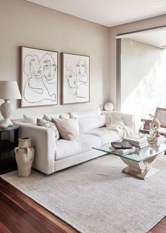 a living room filled with furniture and art on the wall