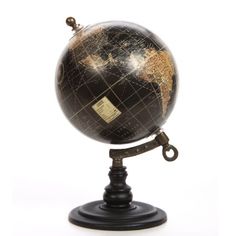 an old black and gold globe on a stand with a tag hanging off the side