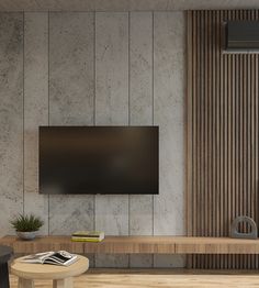 a living room with a large flat screen tv mounted on the wall next to a wooden coffee table