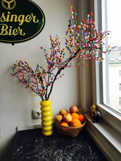 a vase filled with fruit sitting next to a sign that says ginger bier on the wall