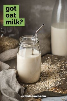 a glass jar filled with oatmeal next to a bottle full of milk