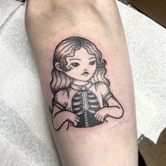 a girl with a skeleton tattoo on her arm