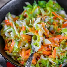 a bowl filled with coleslaw and carrots