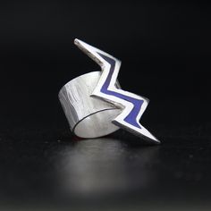 "Lightning Bolt enamel ring adjustable wide band is very comfortable to wear - will not turn around. The base of the ring is cast in FINE Silver, The wide comfort ring band is Sterling Silver and is adjustable. Finally Enamel is added and then fired in a Kiln then polished and tumbled. Material: Fine Silver, Sterling Silver & Enamel ◾Measurements: ADJUSTABLE RING BAND RING BAND: US Ring Size 7 - 8.5 / Width: Approx.     .50\" LIGHTNING BOLT:   Approx. Length - 1.5\"    Width - 1\" Casting is an age old method of creating a design in wax or other material and having this cast. The designs are first created in wax and then the first prototype is cast in Metal - next this is tumbled, polished and then given to be cast in either Bronze, Copper or Silver.  At this stage multiple pieces are cast Lightning Bolt Ring, Rose Quartz Healing, Summer Rings, Unique Anniversary Gifts, Valentine Anniversary, Chalcedony Ring, Adjustable Jewelry, Rose Quartz Ring, Promise Rings For Her