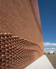 a brick wall that is next to a sidewalk