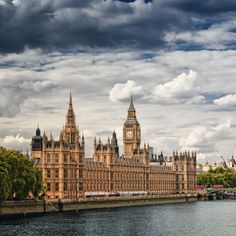 the big ben clock tower towering over the city of london on a partly cloudy day