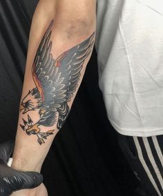 an eagle tattoo on the arm of a man