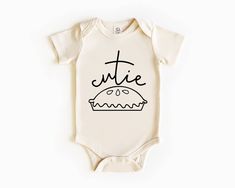 Get ready for some serious cuteness overload with our Cutie Pie Thanksgiving Bodysuit! Made for your little one's first Thanksgiving, this beige bodysuit is the perfect way to show off their cuteness while enjoying some delicious turkey. Don't miss out on this adorable addition to your holiday festivities! Toddler Shirt Svg, Beige Bodysuit, Pie Thanksgiving, First Thanksgiving, Fall Baby, Handmade Business, Cutie Pie, Swim Accessories, Shirt Svg