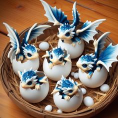 six blue and white dragon figurines sitting in an egg shell on a table