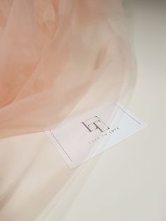 a close up view of a pink fabric with a tag on the bottom of it