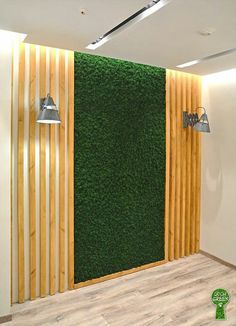 a green wall in the corner of a room with wooden slats and metal fixtures