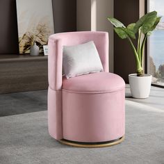 a pink chair sitting in front of a potted plant