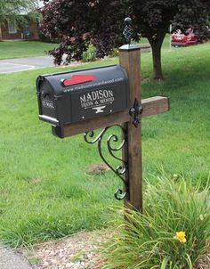 a mailbox with the name madison on it in front of a tree and grass