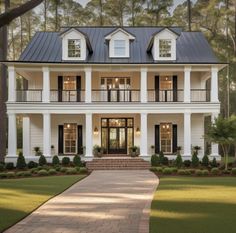 a large white house with black shutters on the front and second story, surrounded by trees