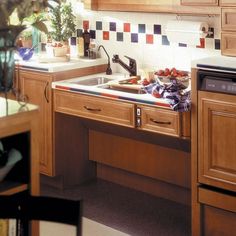 a kitchen with wooden cabinets and counter tops