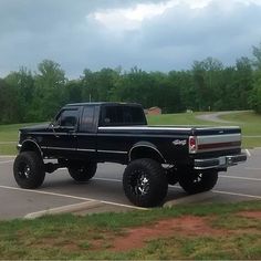 a black pickup truck parked in a parking lot