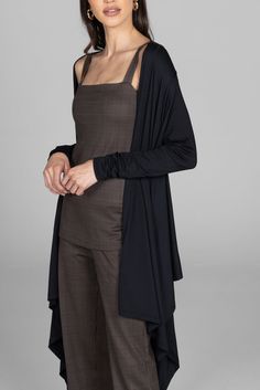 Why we love this: Wrap yourself in style with our knit wrap top. Crafted from soft and stretchy fabric, this versatile ensemble combines comfort and sophistication, making it a perfect choice for effortlessly chic looks. Features: KiraGrace Luxe: Feels ultra-soft and luxurious Light and flowy Perfectly transitions from studio to street Beautiful draping design Made in U.S.A. of imported fabric FIT: Loose and flowy fit COVERAGE: Wrap design SIZING: True to size IMPACT: Light for versatility Fits Elegant Stretch Shrug For Layering, Layering Wrap Top, Versatile Cardigan For Work, Versatile Layering Shrug, Versatile Shrug For Layering, Versatile Fitted Wrap Cardigan, Elegant Wrap Top For Layering, Versatile Open Front Cardigan For Layering, Versatile Solid Wrap Cardigan