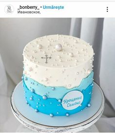 a cake with blue and white frosting on the top is decorated like a cross